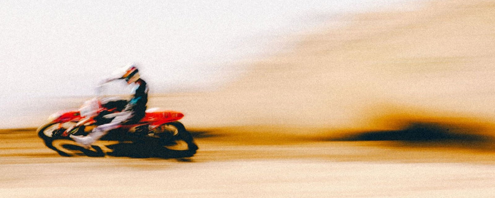 Fox rider at speed on a dirt track